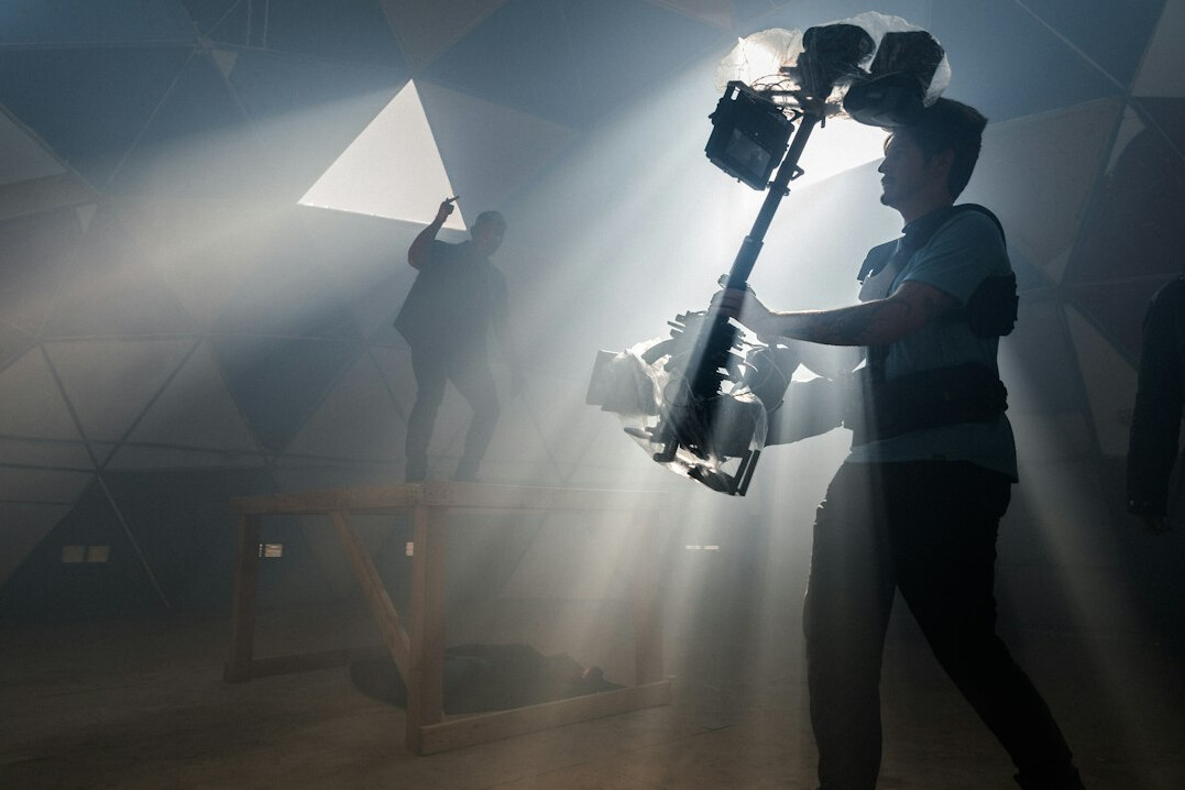 cinematographer adjusting film lights